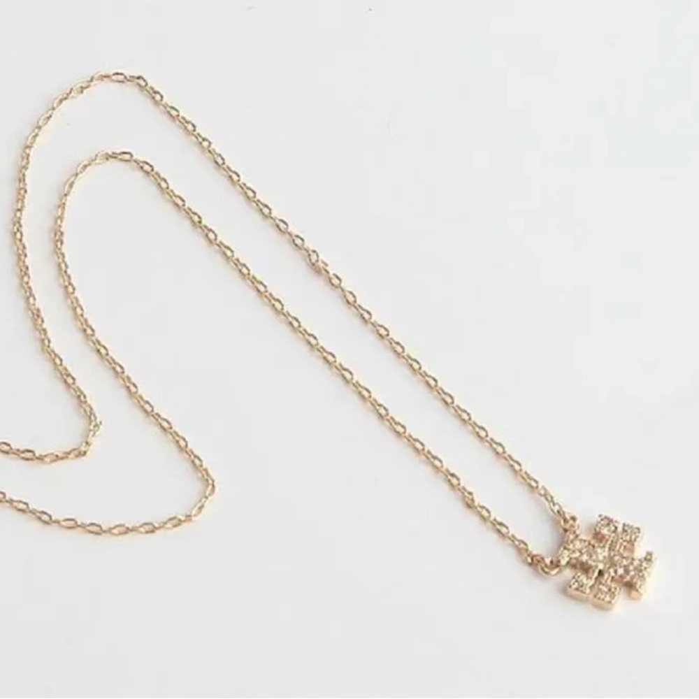 Authentic Tory Burch Gold Kira Crystal Charm Logo Pendant Necklace. New with bag